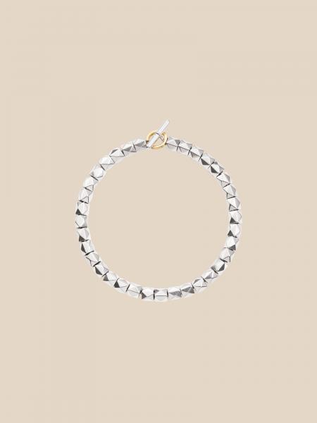 Bracciale, borchie e ago in argento. anello brisé oro giallo