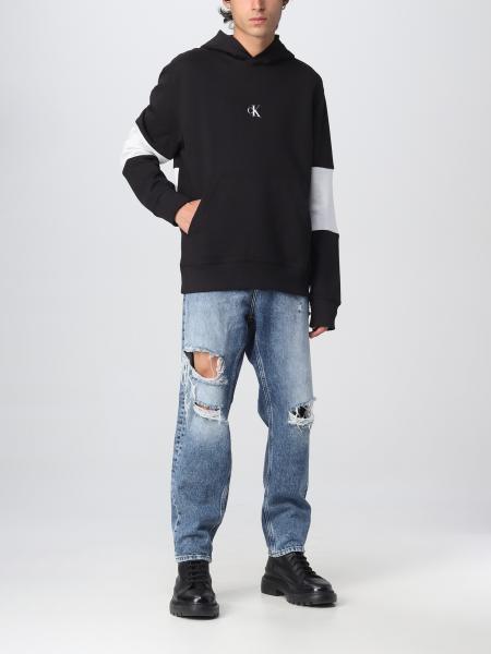 black sweatshirt and jeans