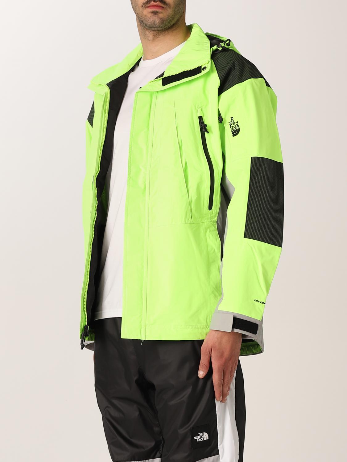 green and white north face jacket