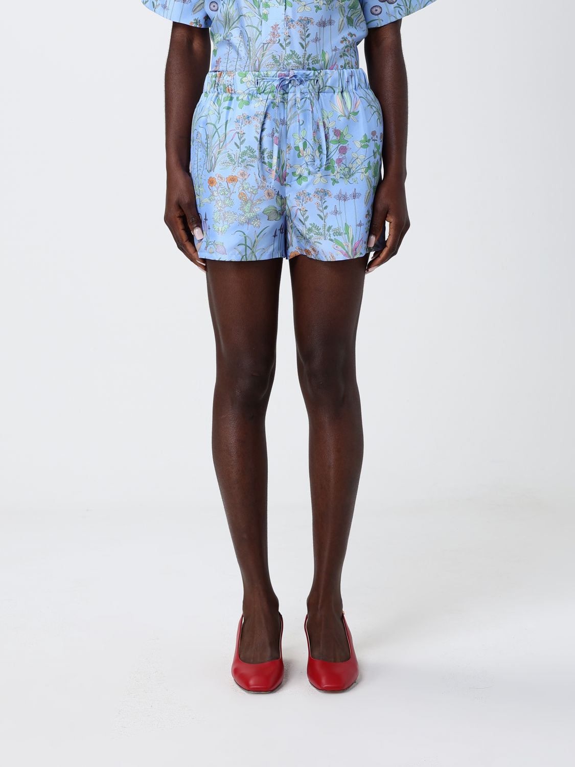 GUCCI Pantaloncini in seta con stampa floreale