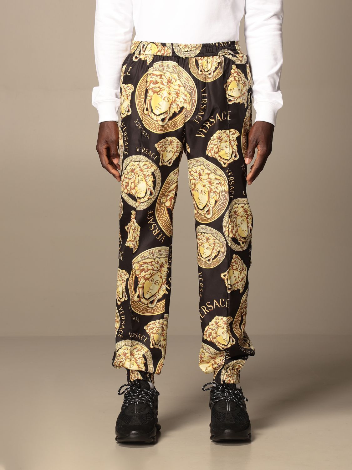 VERSACE: nylon jogging trousers with all-over medusa heads - Black