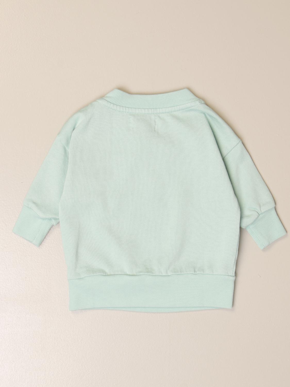 white sweatshirt with green writing