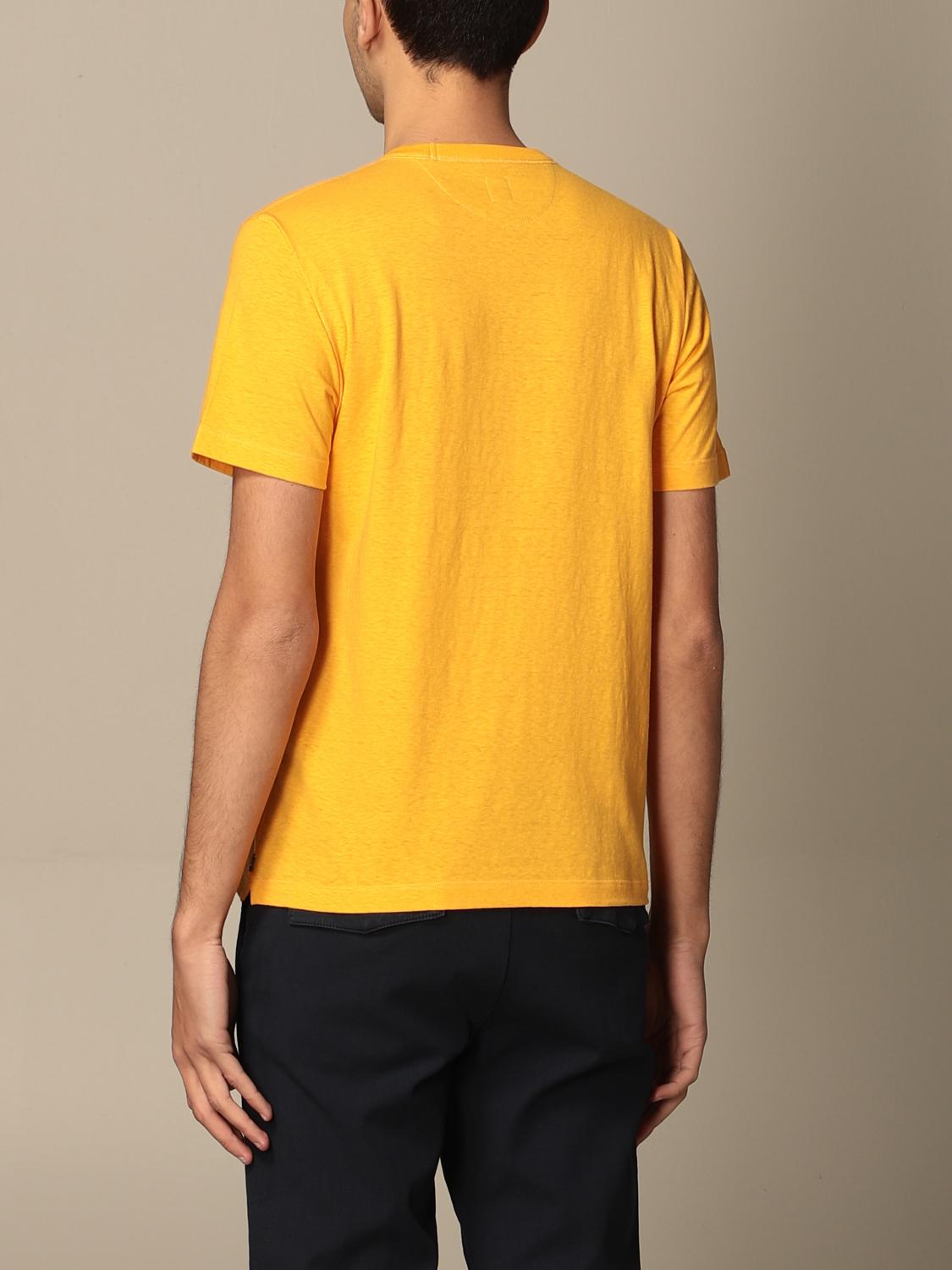 grey shirt with yellow writing